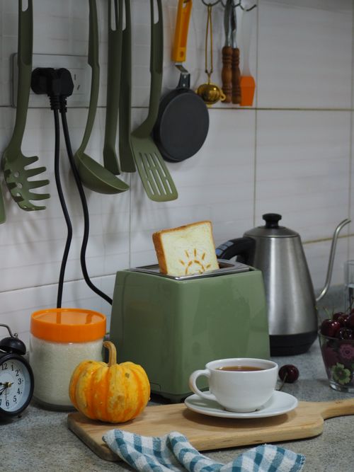 Free Warm kitchen setting with toaster and tea, ideal for cozy morning vibes. Stock Photo