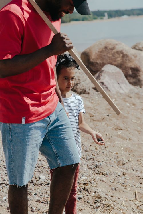 Free Family bonding on a summer beach walk, exploring nature together. Stock Photo
