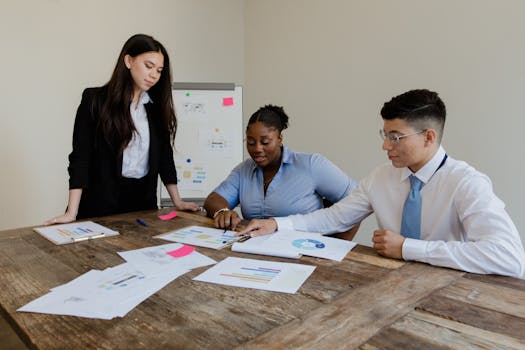 Group of diverse colleagues engaged in a productive office meeting around a table.
