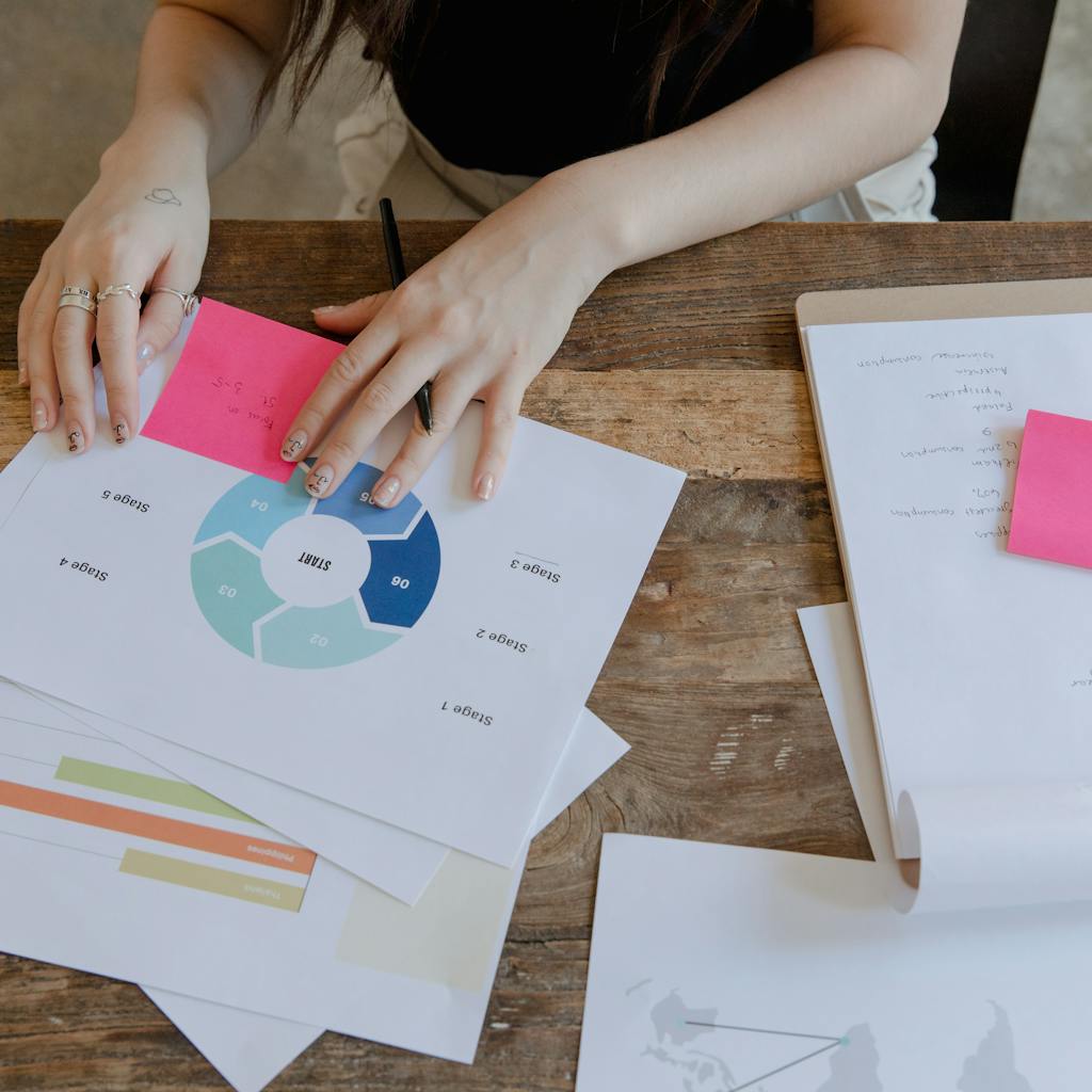 Woman working on charts, highlighting data analysis and marketing strategies.