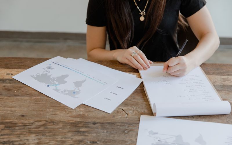 Business owner planning with maps and documents at a desk