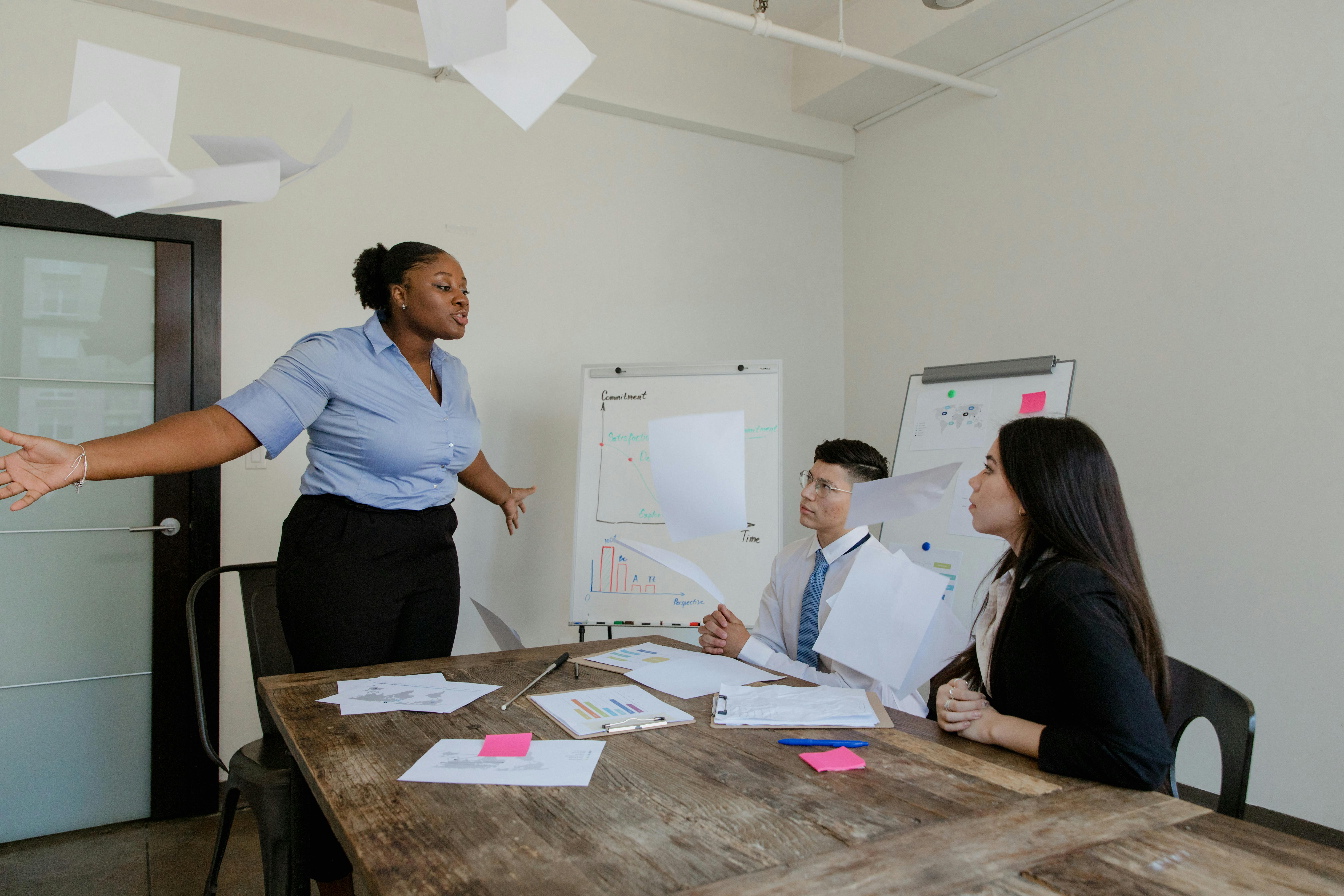 Free Woman Throwing Documents in Office Stock Photo