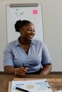 Woman in Blue Polo Shirt Holding Black Pen