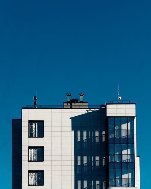 Minimalist urban building facade with clear blue sky in Saint Petersburg, Russia.