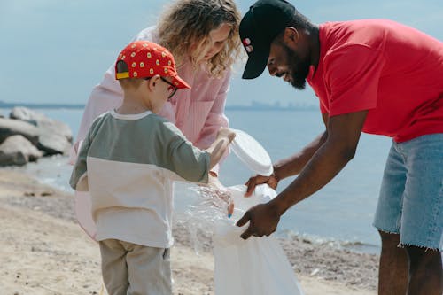 Boy, Man and Girl Cleaning Beach