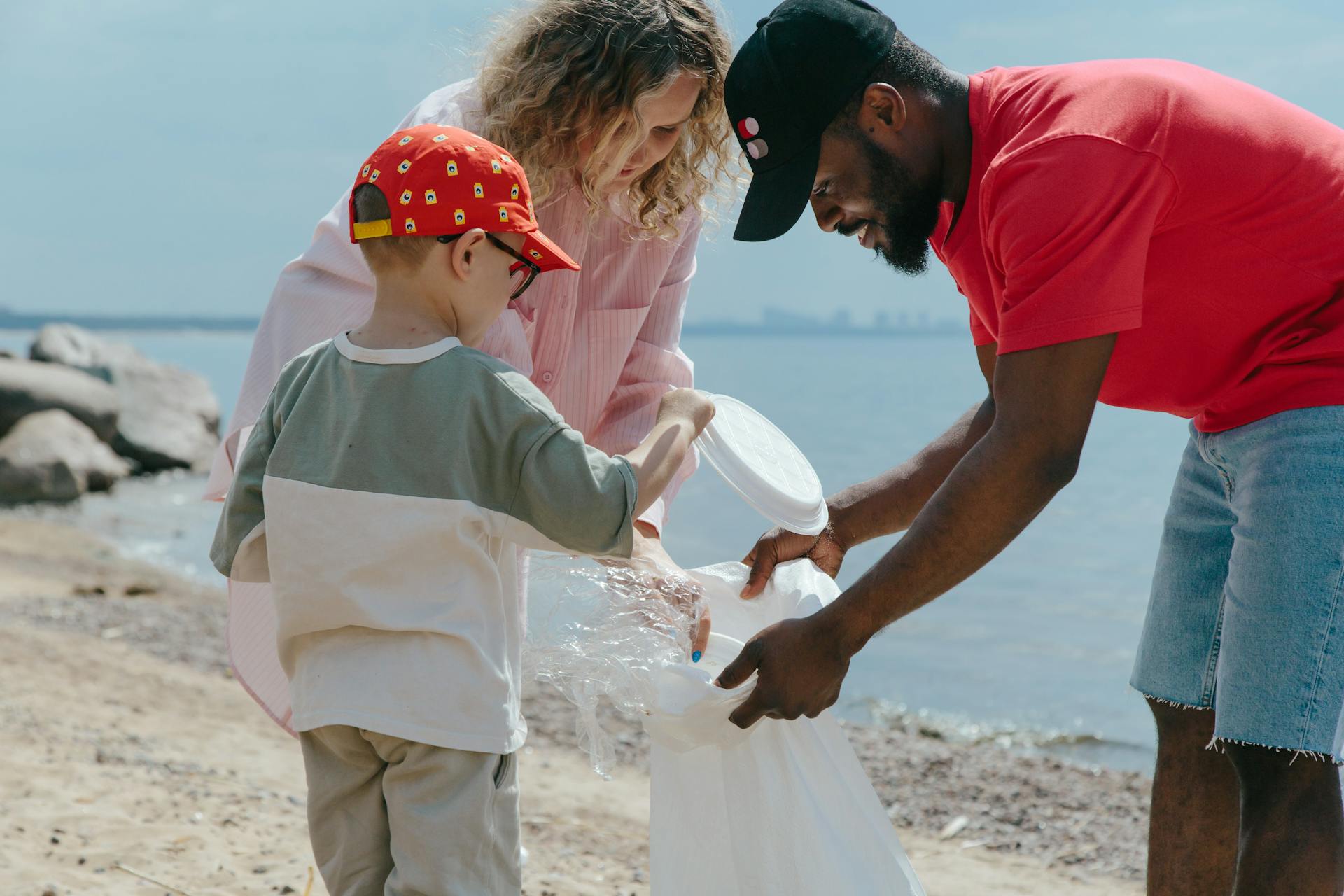 Boy, Man and Girl Cleaning Beach