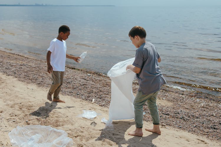 Boys Collecting Garbage At The Beach