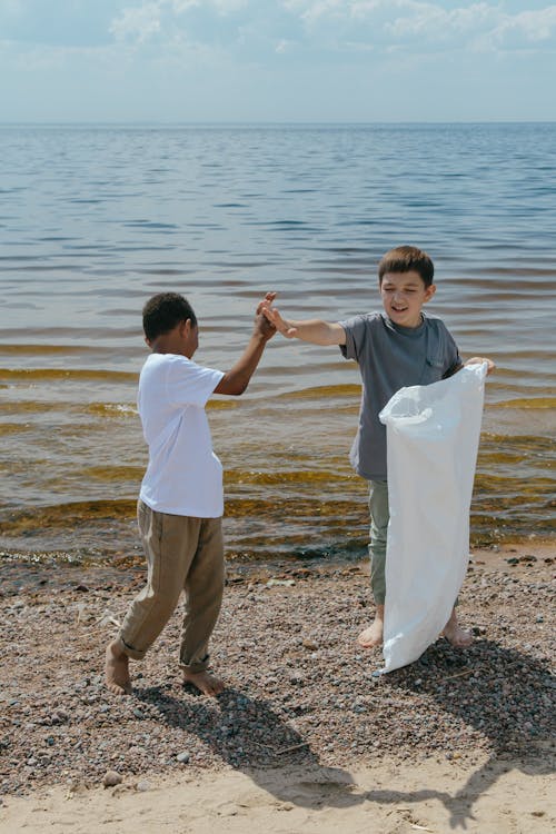 Free Boys Cleaning Beach Stock Photo