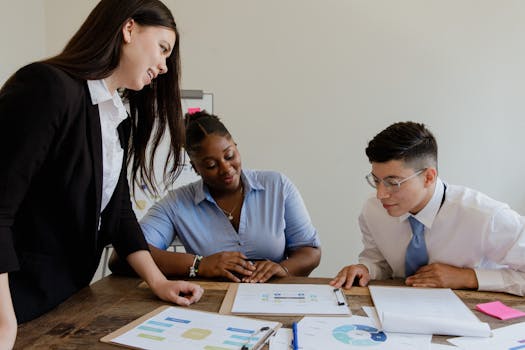 Diverse team of professionals collaborating over documents in an office environment.
