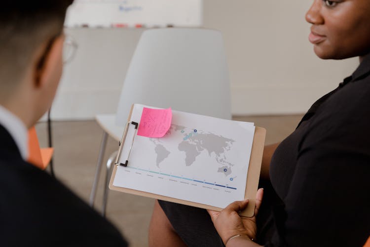 A Person Holding A Clipboard With Drawing