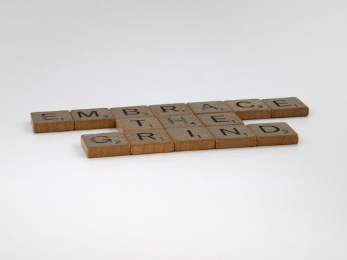 Brown Wooden Scrabble Tiles on White Surface