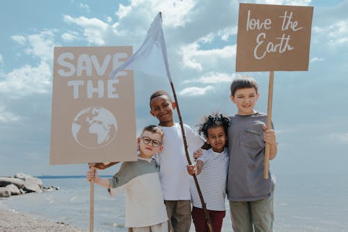 Free Children Standing Together while Holding Signages Stock Photo