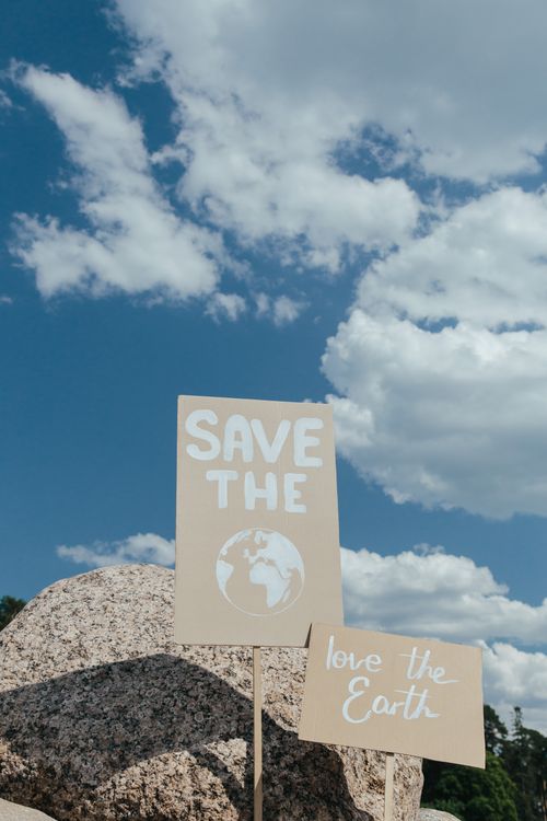 Free Protest signs for environmental protection against blue sky with clouds. Stock Photo