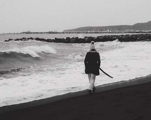 Free Person Walking on Beach Stock Photo