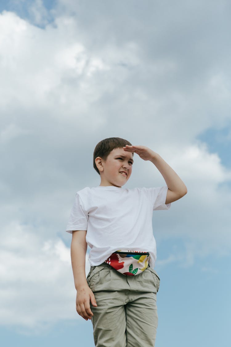 A Boy With A Fanny Pack Looking Afar