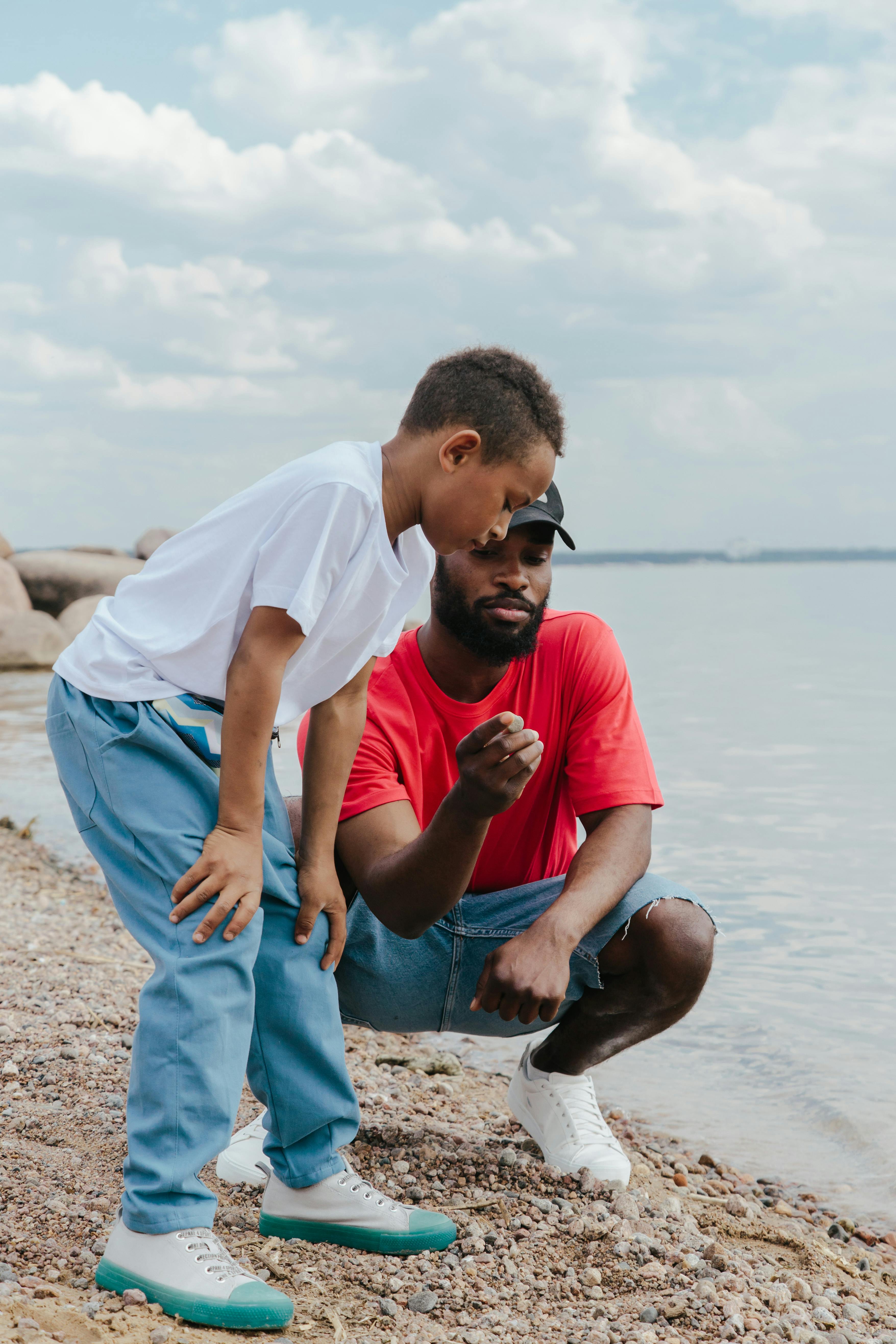 a father and son having conversation on the shore