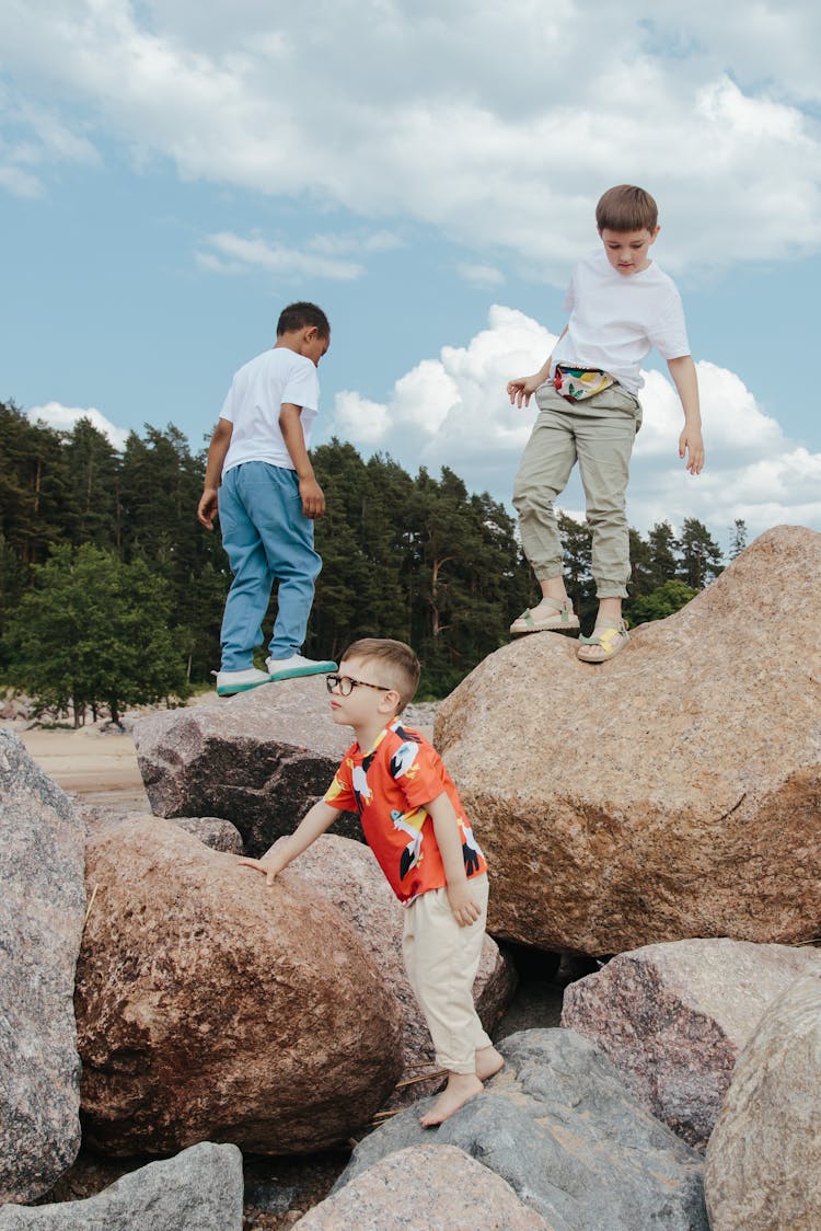 Kids Standing On Rocks