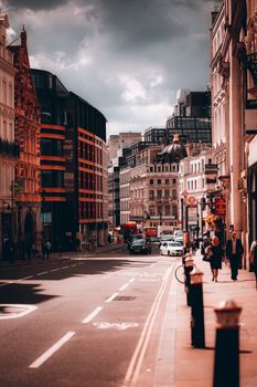An atmospheric view of a busy street in London, showcasing classic and modern architecture.