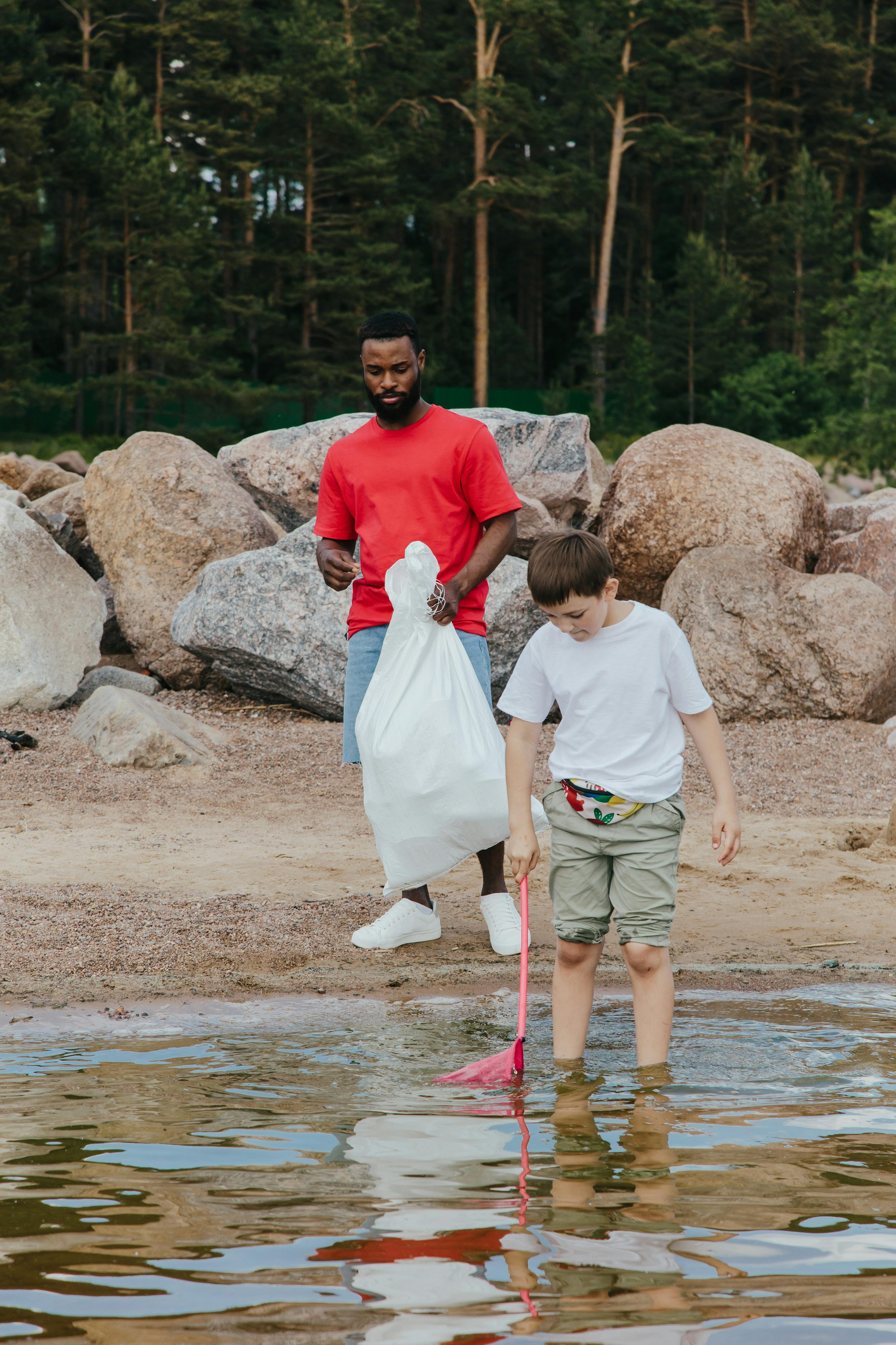 two men cleaning at the beach