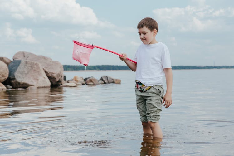 A Boy Cleaning At The Beach