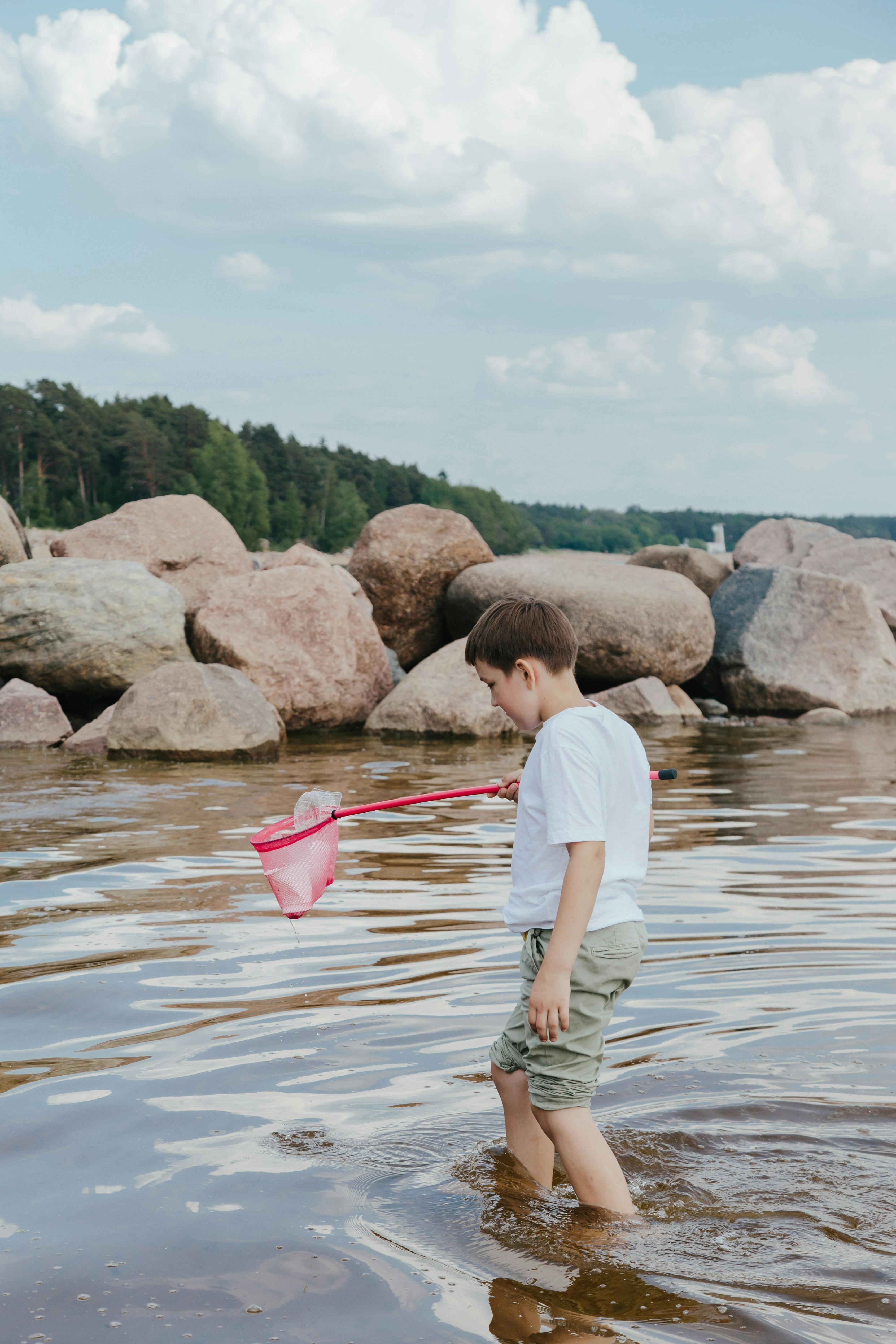 a boy cleaning at the beach