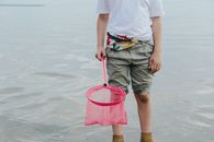 Person in White Shirt and Green Shorts Holding Pink Scrunch Net