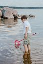 A Boy in White Shirt Holding Pink Scrunch Net