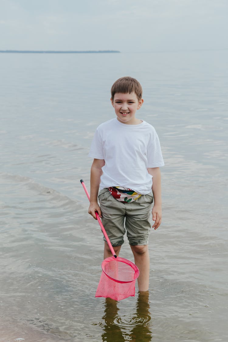 A Boy Cleaning At The Beach