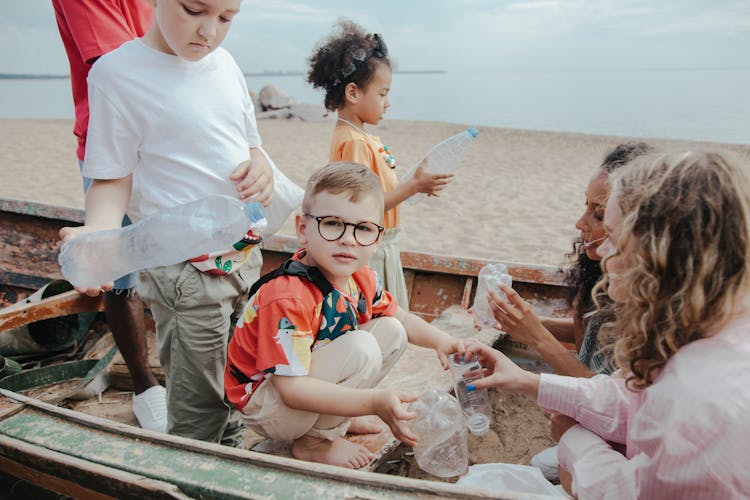 Kids Cleaning At The Beach