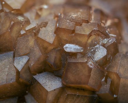 Detailed macro shot of brown calcite crystals with visible texture and translucent properties.