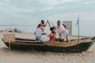 People Riding on Brown Boat on Beach