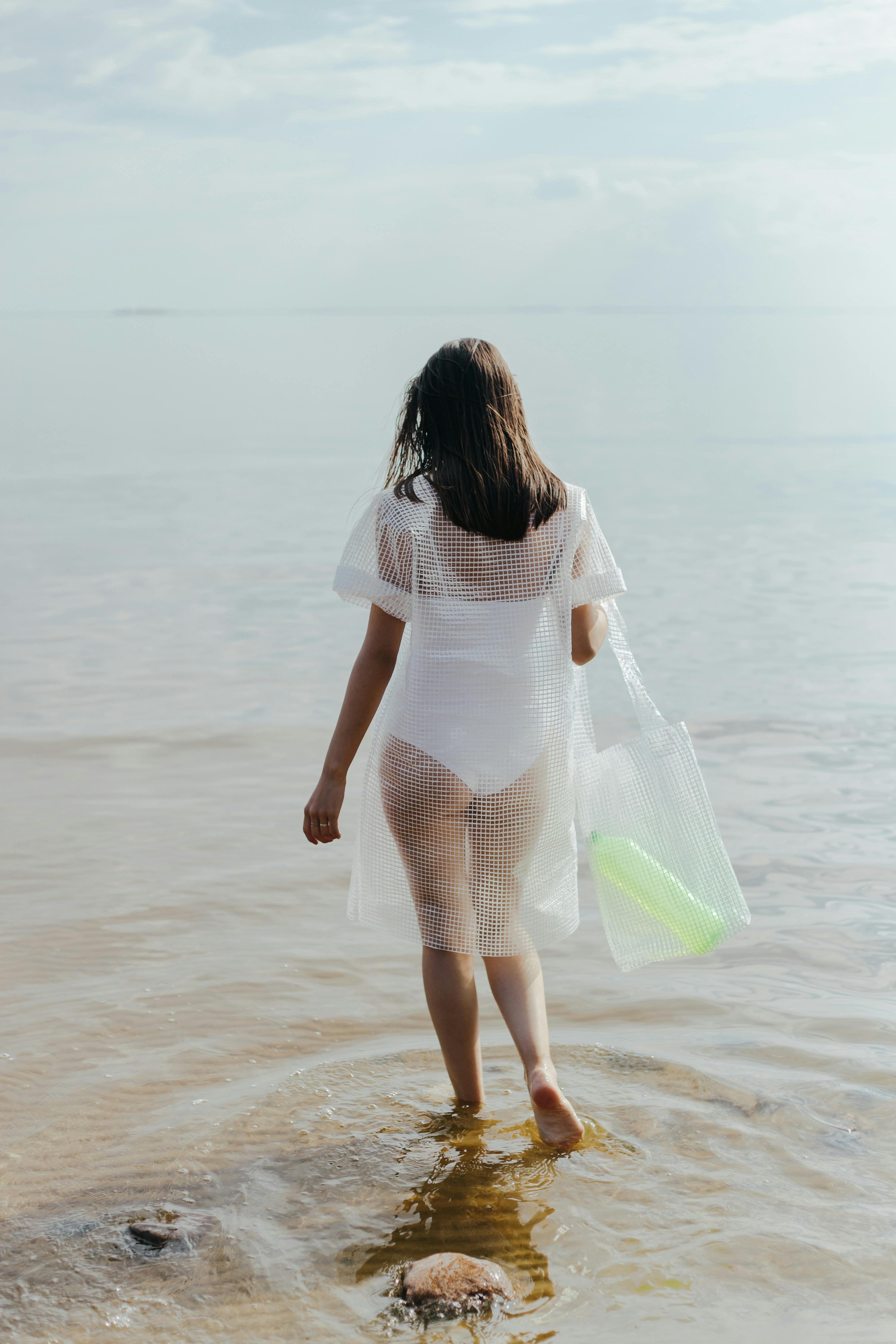 Woman in White See Through Dress Standing on Beach  Free Stock Photo