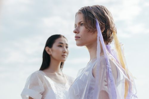 Free Explore modern fashion with two women in avant-garde outfits, captured outdoors during the day. Stock Photo