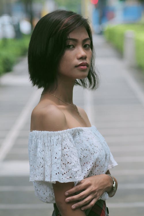 A Woman Wearing a White Off Shoulder Top