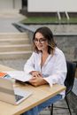 Woman in White Blazer Sitting on Chair