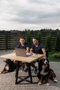 Group of People Sitting on Chair in Front of Table With Macbook Pro on Top