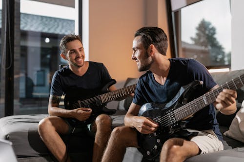 Two Men Playing Electric Guitars