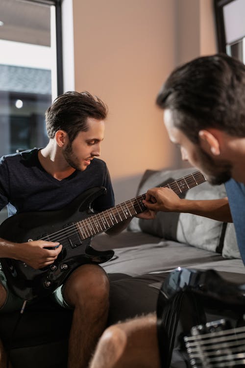 Men Playing Guitars at Home
