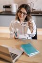 Woman in White Coat Holding Clear Drinking Glass