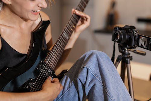 Close-Up Shot of a Woman Playing Electric Guitar