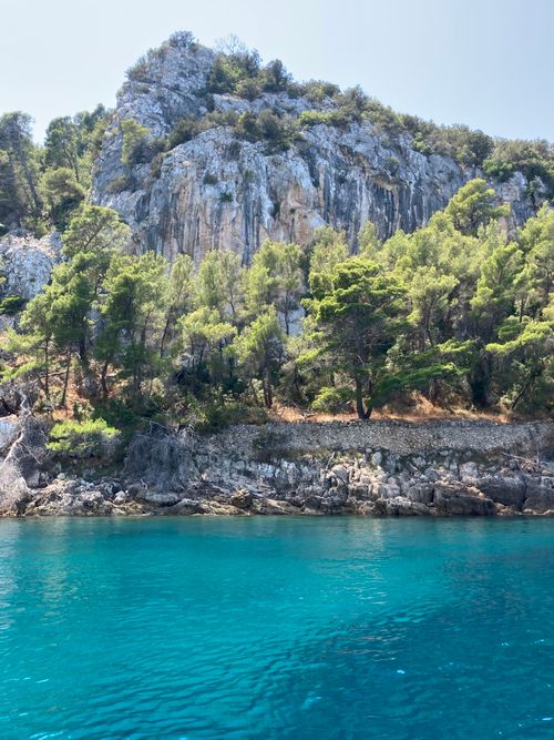 Free Stunning view of rocky coastal cliffs and turquoise waters under a bright sky. Stock Photo
