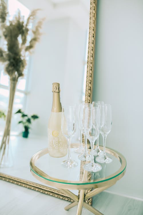 
A Bottle beside Champagne Glasses