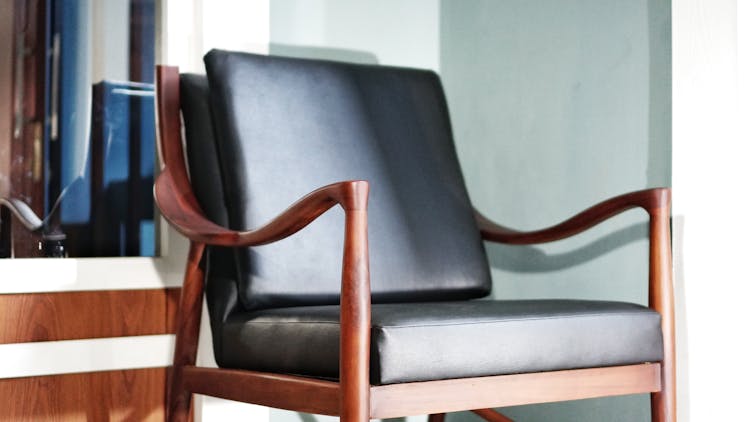 Brown Wooden Chair With Leather Wrapped Cushions