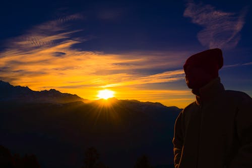 Free Silhouette of Person Near Mountain during Golden Hour Stock Photo