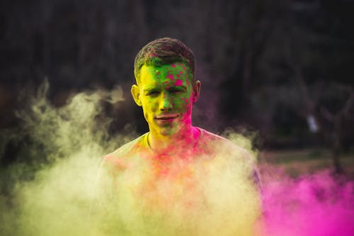Free Man Painted With Green and Purple Paints Photo Stock Photo