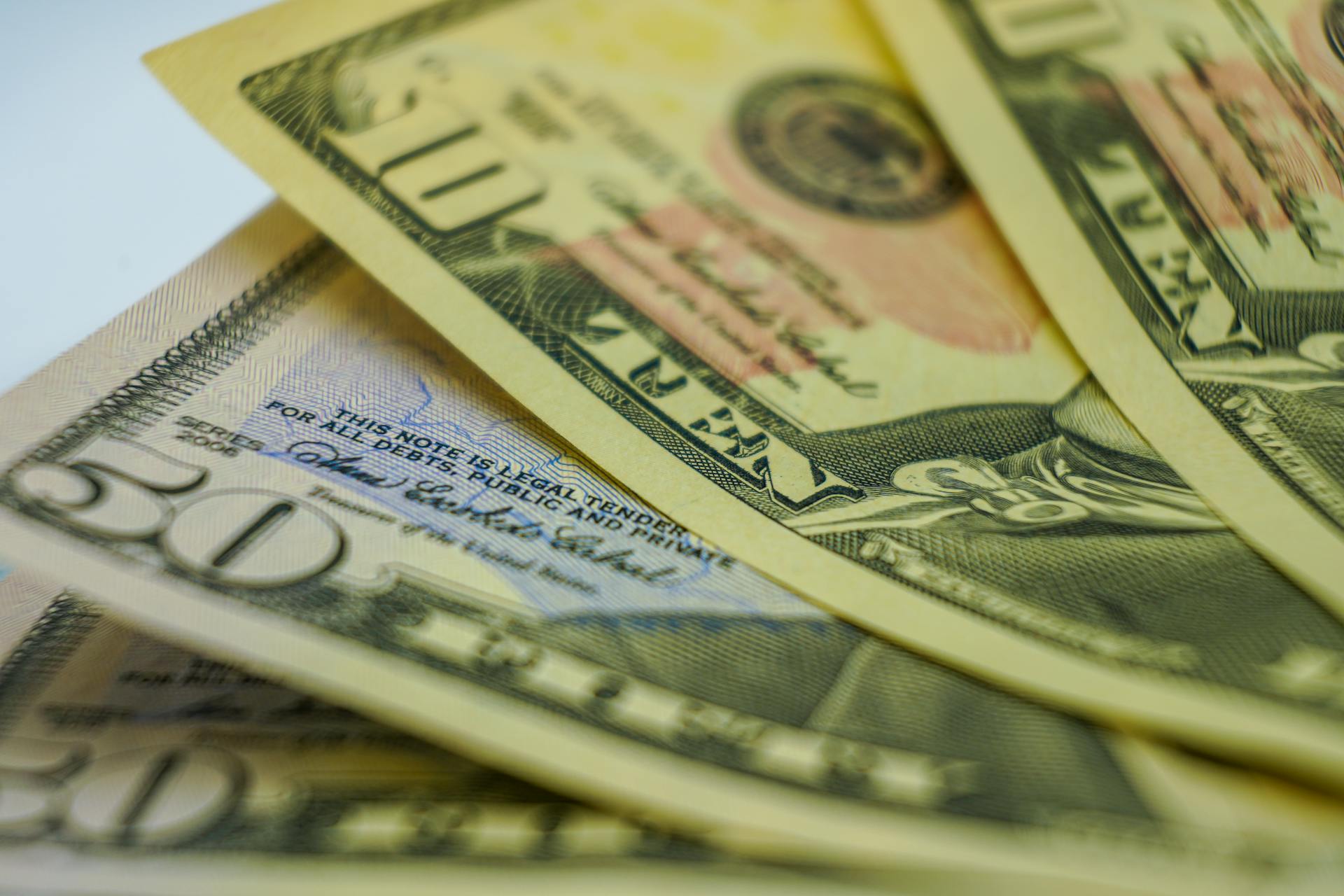 Close-up view of multiple American dollar bills showcasing finance and currency details.