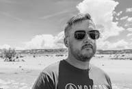 Grayscale Photo of a Man Wearing Sunglasses