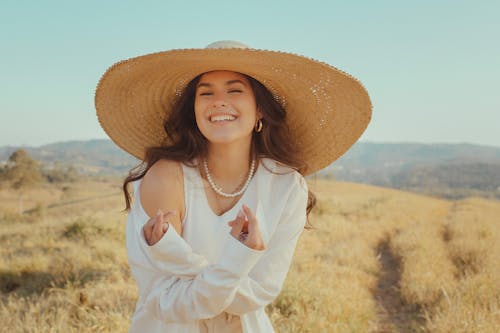 A Woman in White Dress Wearing Brown Straw Hat