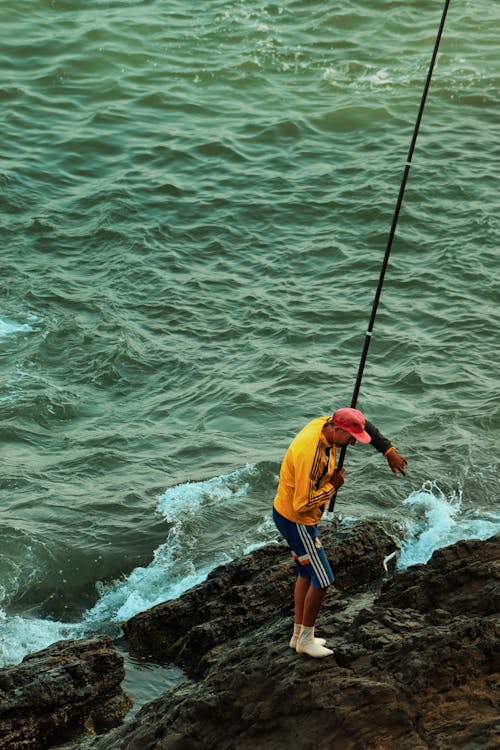 Balık tutmak, balıkçı, deniz içeren Ücretsiz stok fotoğraf