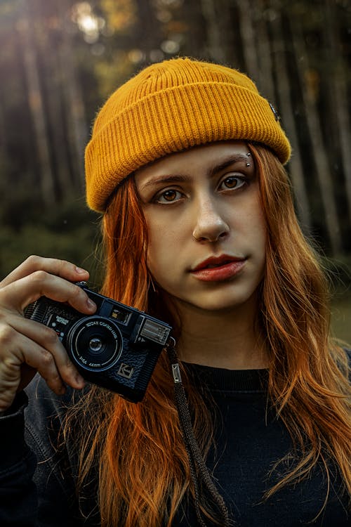 Woman Wearing a Beanie Holding a Camera